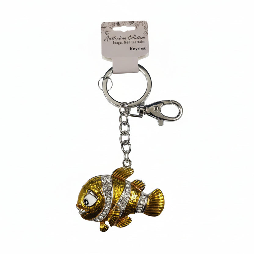 Gold clownfish-shaped keychain with a tag