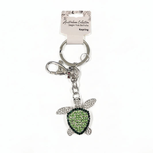 Keychain with turtle charm and engraved tag on a white background