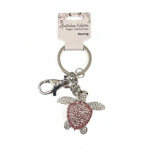 Keychain with a pink turtle charm on a white background